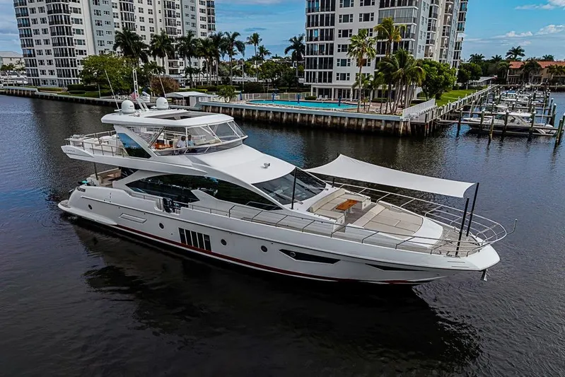 Lucky 7 Yacht Photos Pics Luxury 2017 Azimut 80 yacht cruising near waterfront buildings and marina.