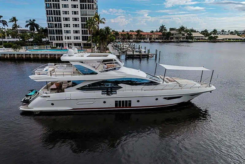 Lucky 7 Yacht Photos Pics Luxurious 2017 Azimut 80 yacht docked near waterfront residences, showcasing sleek design and elegance.