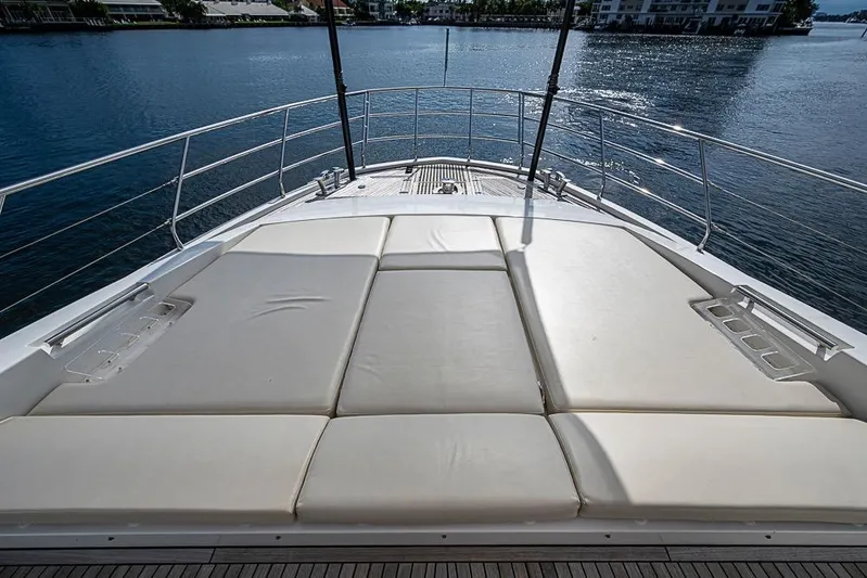 Lucky 7 Yacht Photos Pics Luxurious sunbathing deck on a 2017 Azimut 80 yacht, overlooking serene waters.