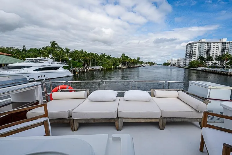 Lucky 7 Yacht Photos Pics Luxurious 2017 Azimut 80 yacht deck with plush seating, overlooking a scenic waterway.