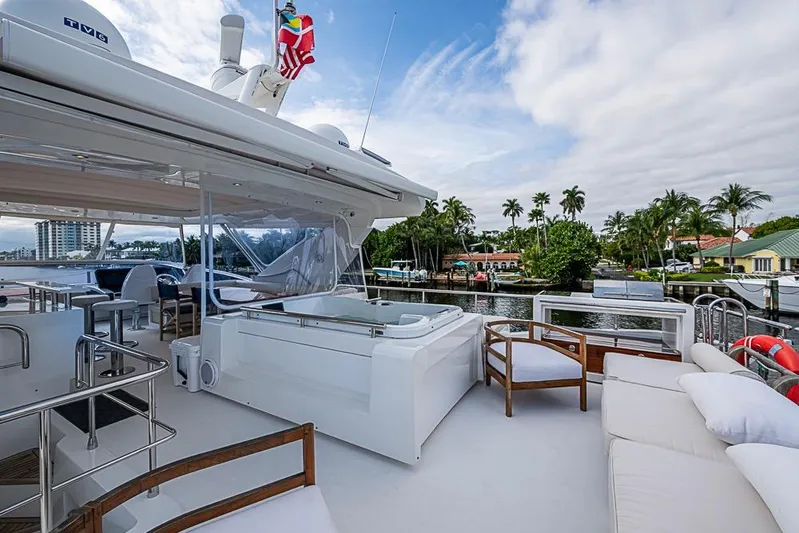 Lucky 7 Yacht Photos Pics Luxurious 2017 Azimut 80 yacht deck with seating, jacuzzi, and scenic waterfront view.