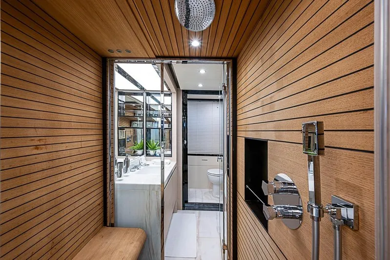 Lucky 7 Yacht Photos Pics Luxurious bathroom interior of 2017 Azimut 80 yacht with wood paneling and modern fixtures.