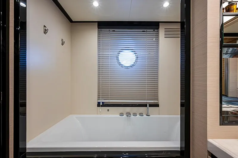Lucky 7 Yacht Photos Pics Luxurious bathroom on 2017 Azimut 80 yacht with modern bathtub and porthole window.