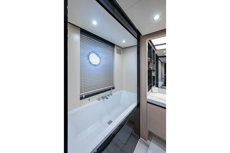 Lucky 7 Yacht Photos Pics Luxurious bathroom interior on 2017 Azimut 80 yacht with modern bathtub and porthole window.