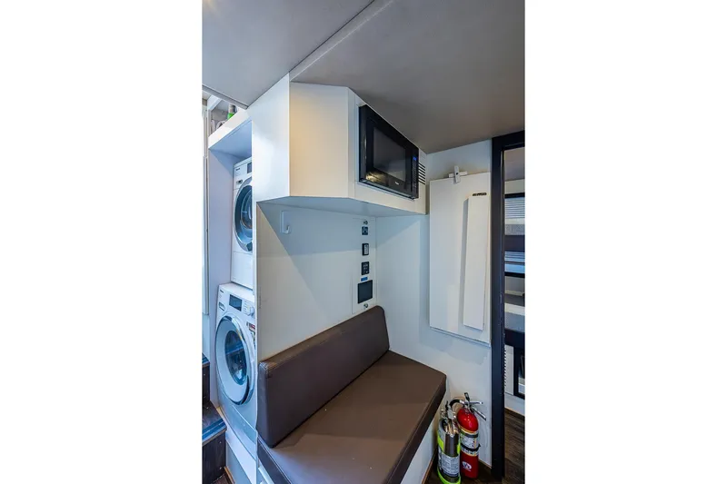 Lucky 7 Yacht Photos Pics Laundry area in 2017 Azimut 80 yacht with washer, dryer, and seating.