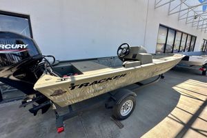 2025 Tracker Grizzly 1648 SC boat on trailer, featuring Mercury outboard motor.