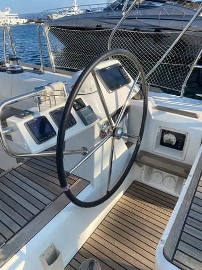  Yacht Photos Pics 2014 Beneteau Sense 50 yacht cockpit with steering wheel and navigation instruments.