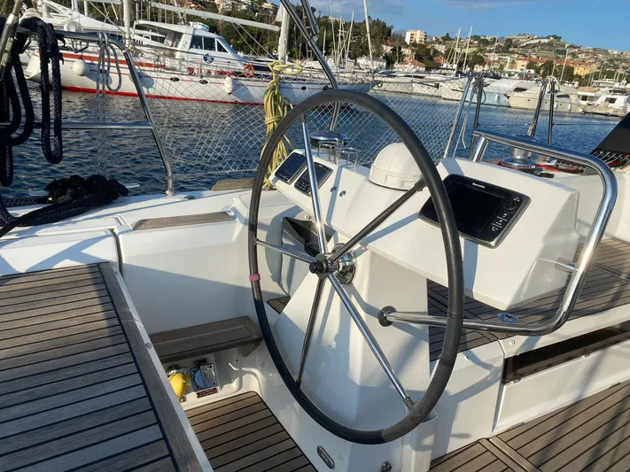  Yacht Photos Pics Steering wheel of 2014 Beneteau Sense 50 yacht in marina setting.