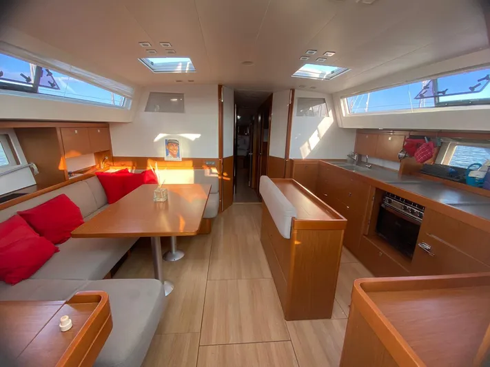  Yacht Photos Pics Interior of 2014 Beneteau Sense 50 yacht with modern kitchen and cozy seating area.
