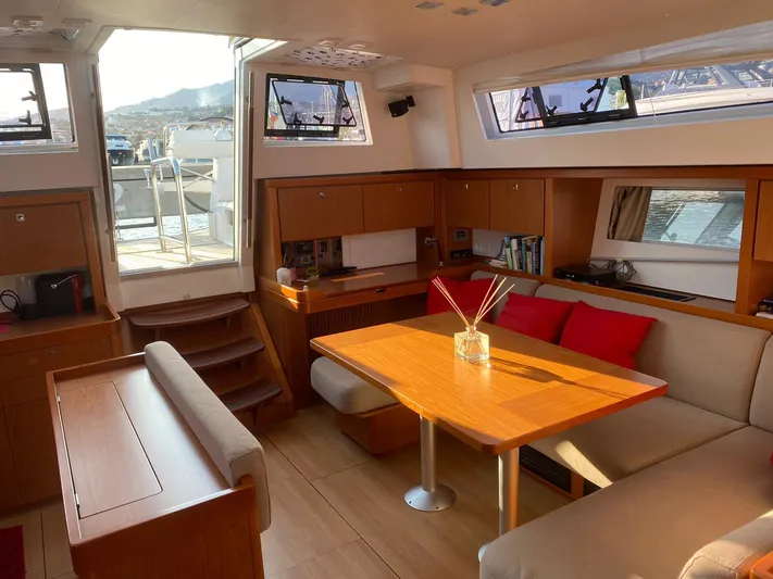  Yacht Photos Pics Luxurious interior of 2014 Beneteau Sense 50 yacht with elegant wood finishes and seating.