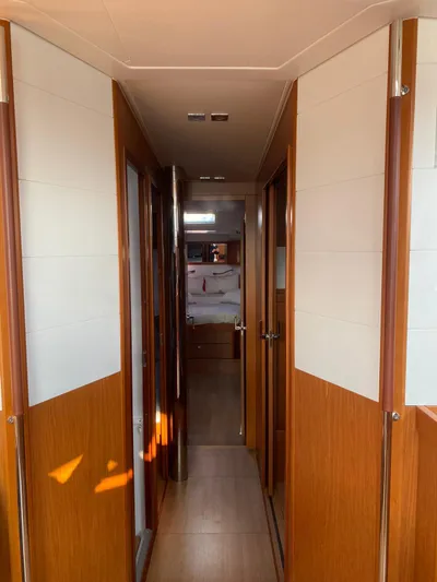  Yacht Photos Pics Interior hallway of 2014 Beneteau Sense 50 yacht, featuring wood paneling and modern design.
