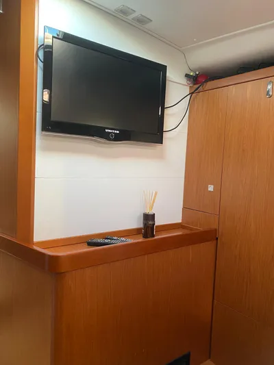  Yacht Photos Pics Interior of 2014 Beneteau Sense 50 yacht with TV and wooden cabinetry.