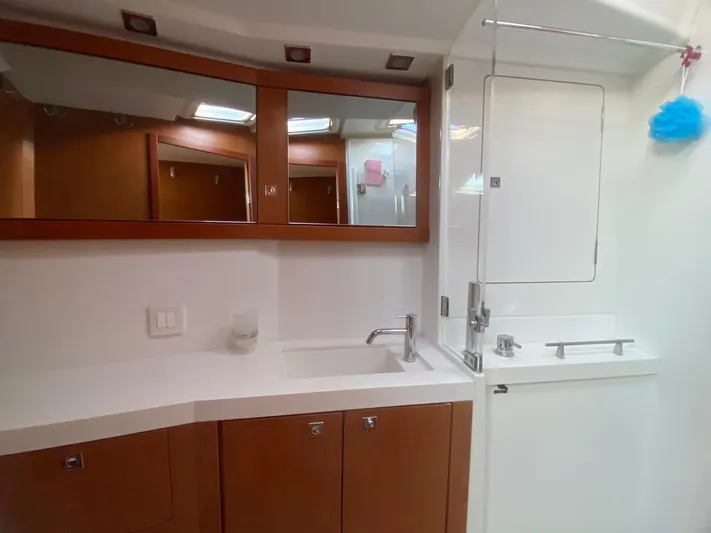  Yacht Photos Pics Luxurious bathroom in 2014 Beneteau Sense 50 yacht with modern fixtures and wooden cabinetry.