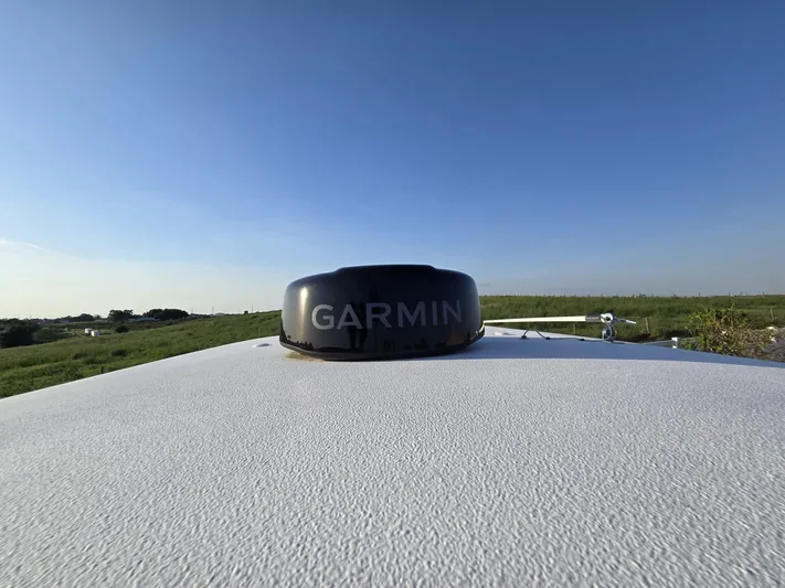  Yacht Photos Pics Garmin device on 2022 Sea Hunt Gamefish 30 Forward Seating boat under clear blue sky.