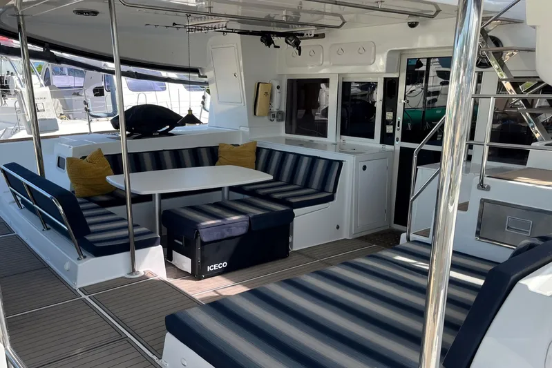  Yacht Photos Pics Spacious interior of 2018 Lagoon 450S catamaran with striped seating and dining area.