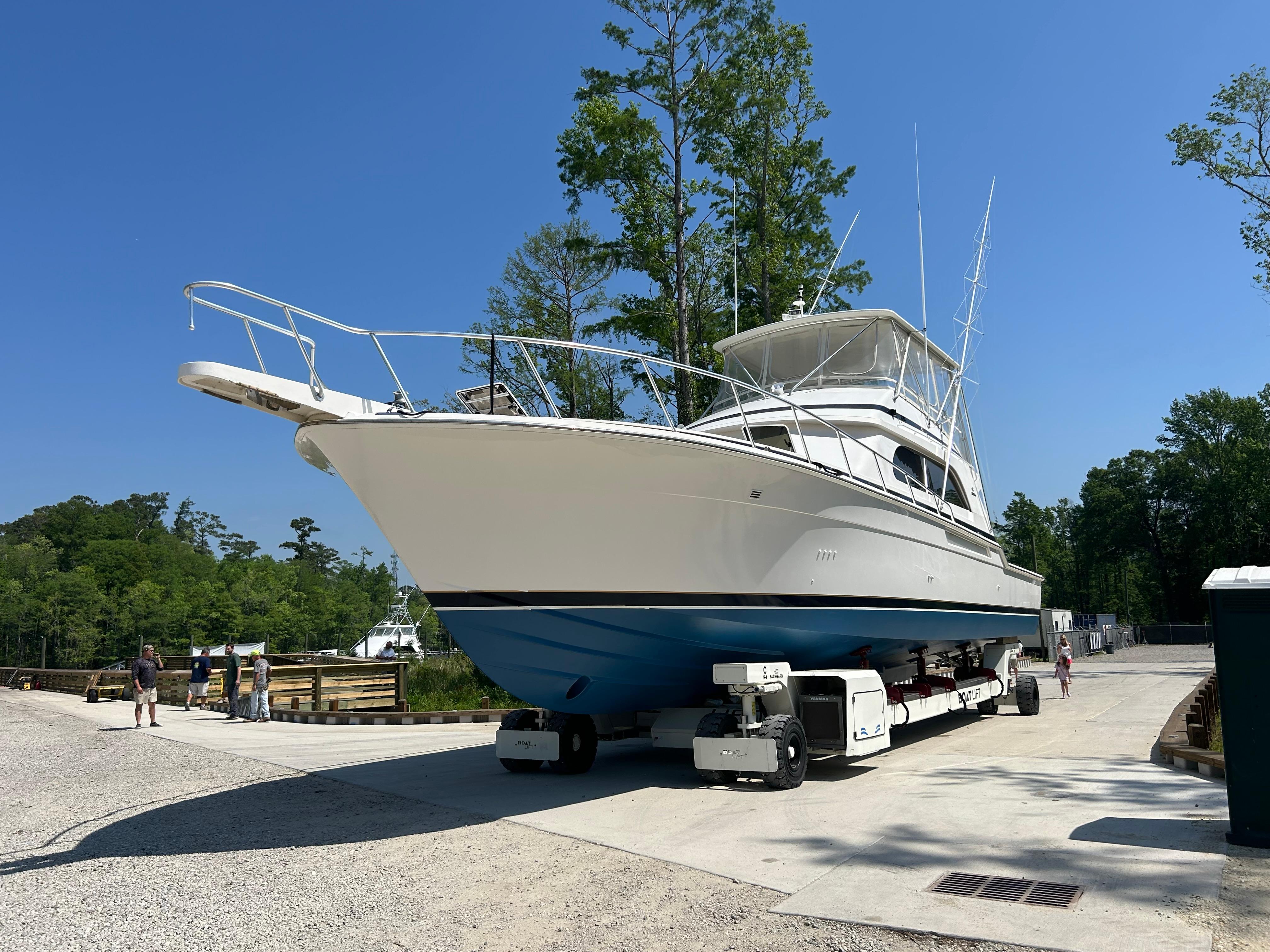 1999 Bertram 60 Convertible yacht on a trailer, ready for launch.