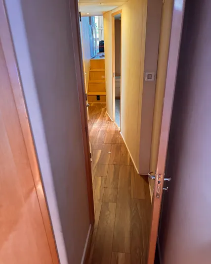 Satisfaction Yacht Photos Pics Interior hallway of 1999 Bertram 60 Convertible yacht with wooden flooring.