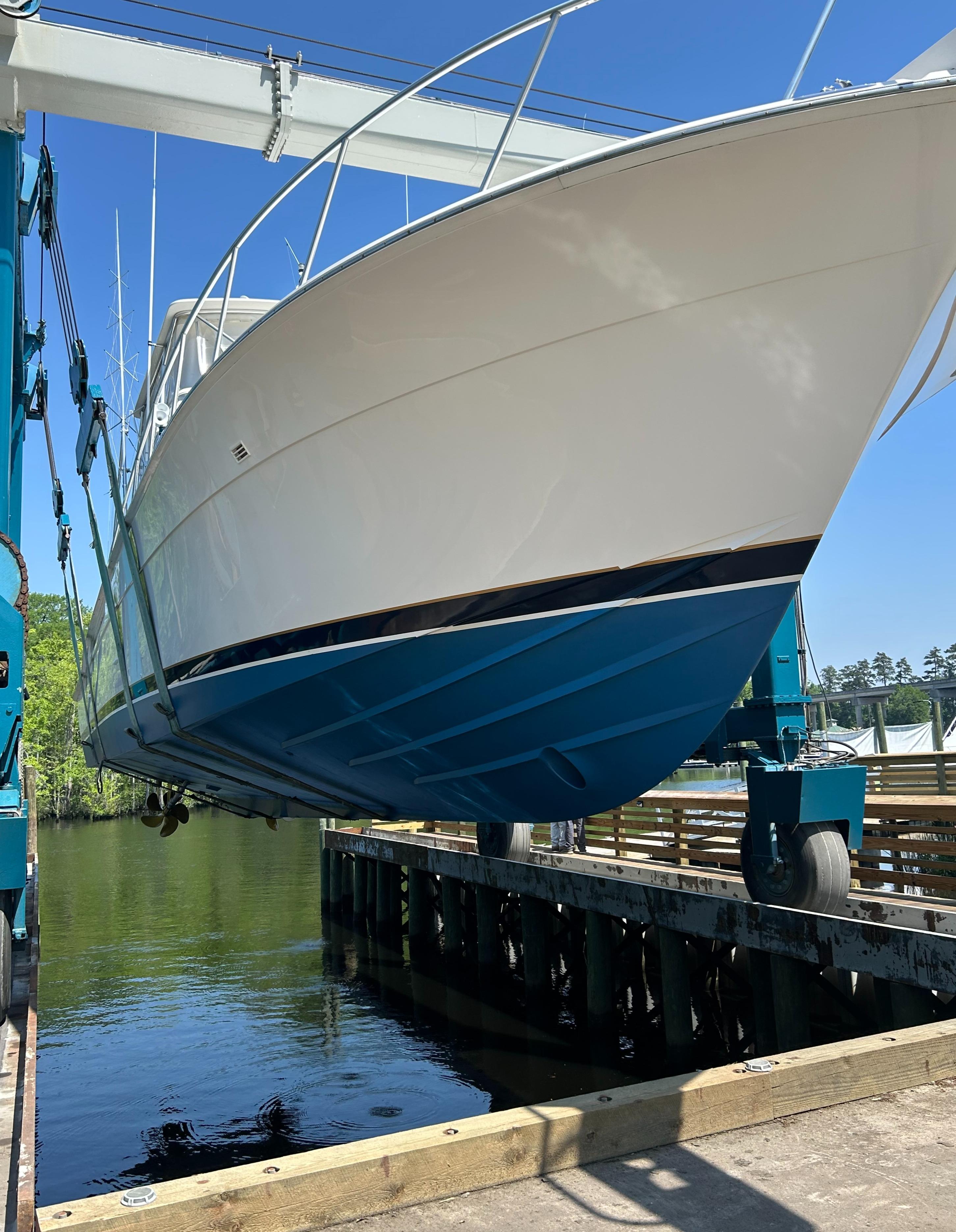 1999 Bertram 60 Convertible boat being lifted out of the water.