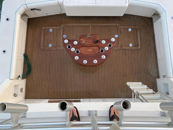 Satisfaction Yacht Photos Pics Bertram 60 Convertible 1999 fishing deck with rod holders and teak flooring.