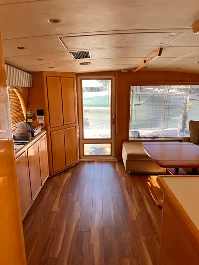 Satisfaction Yacht Photos Pics Interior of a 1999 Bertram 60 Convertible yacht with wooden flooring and cabinetry.