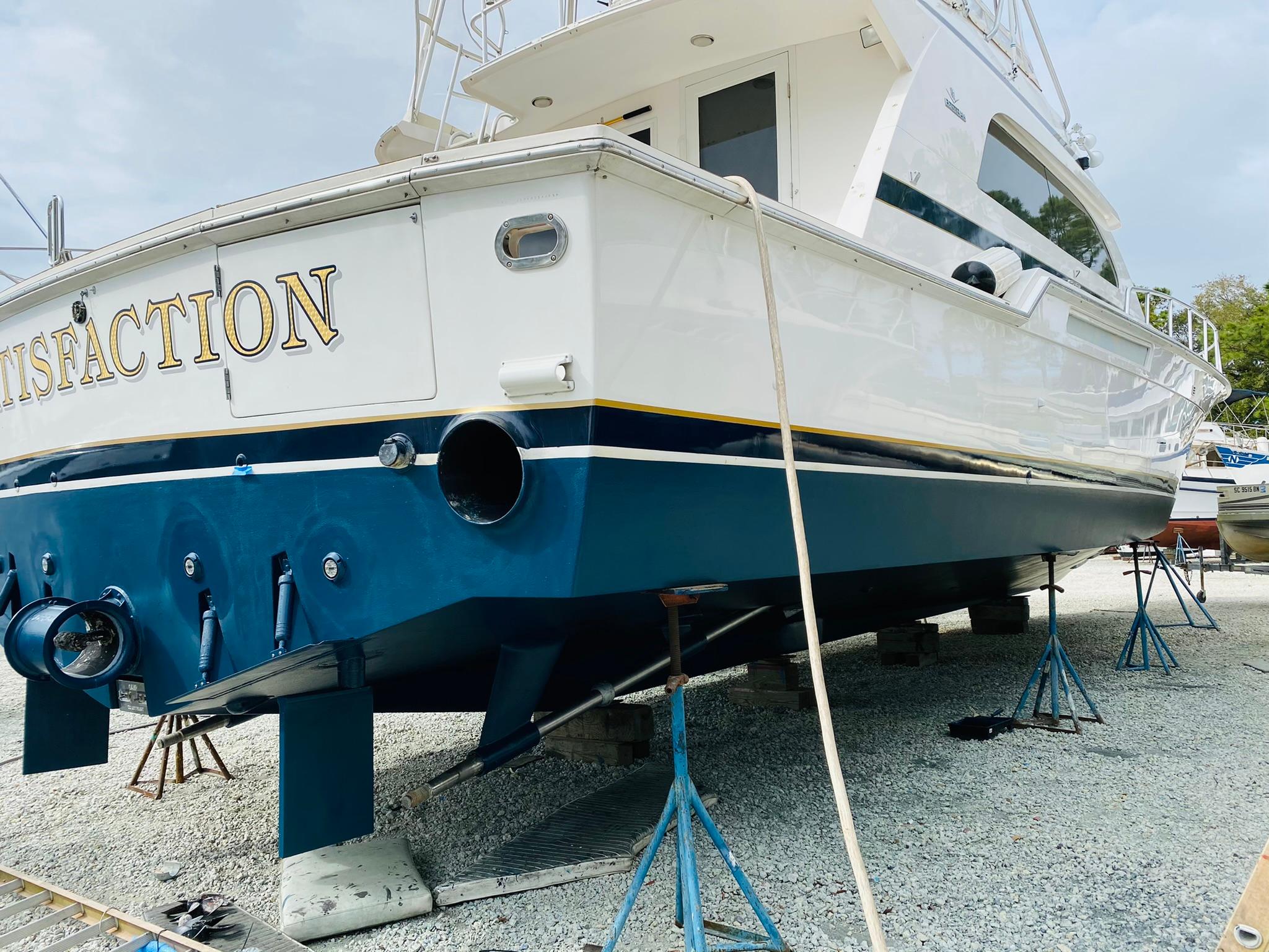 1999 Bertram 60 Convertible yacht on dry dock for maintenance.