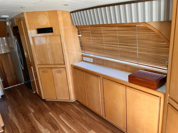 Satisfaction Yacht Photos Pics Interior of 1999 Bertram 60 Convertible yacht with wooden cabinets and blinds.