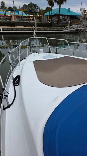 Always Friday Yacht Photos Pics 2000 Cruisers Yachts 4450 Express Motoryacht docked, front deck view.