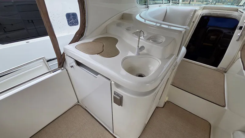 Always Friday Yacht Photos Pics Interior of 2000 Cruisers Yachts 4450 Express Motoryacht with sink and countertop.