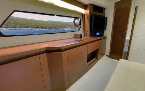 Ultima Risa Yacht Photos Pics Interior of a 2016 Prestige 450 S yacht, featuring sleek cabinetry and a scenic window view.