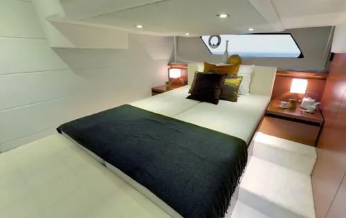 Ultima Risa Yacht Photos Pics Luxurious bedroom interior of 2016 Prestige 450 S yacht with modern decor and ambient lighting.
