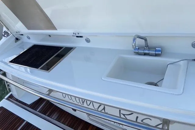 Ultima Risa Yacht Photos Pics Outdoor kitchen on a 2016 Prestige 450 S yacht with sink and grill.