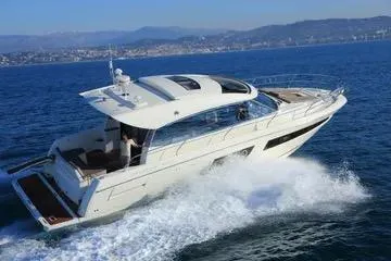 Ultima Risa Yacht Photos Pics 2016 Prestige 450 S yacht cruising on open sea with scenic coastal backdrop.