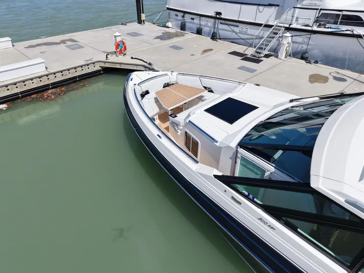 The Legacy Yacht Photos Pics 2022 Formula 500 SSC luxury boat docked at marina, showcasing sleek design and spacious deck.