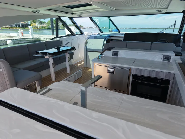 The Legacy Yacht Photos Pics Luxurious interior of 2022 Formula 500 SSC yacht with modern seating and kitchen area.