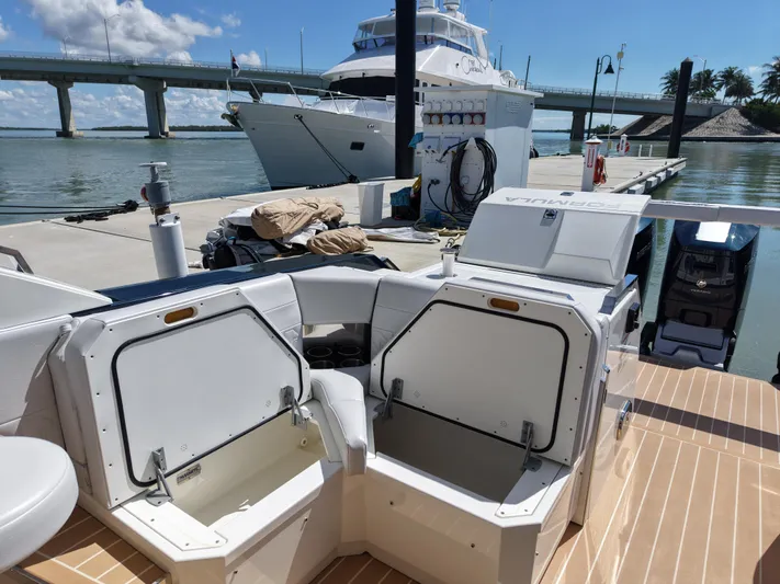 The Legacy Yacht Photos Pics 2022 Formula 500 SSC boat docked, open storage compartments, scenic waterfront view.