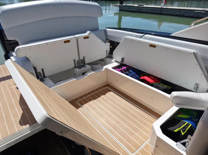 The Legacy Yacht Photos Pics 2022 Formula 500 SSC boat storage compartments with open hatches and life jackets.