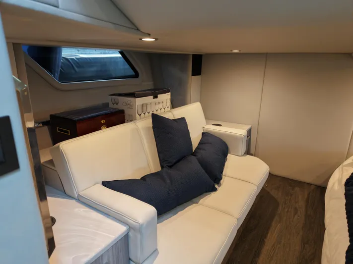 The Legacy Yacht Photos Pics 2022 Formula 500 SSC interior with white sofa and navy cushions.
