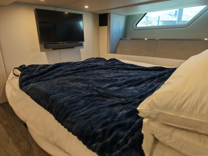 The Legacy Yacht Photos Pics Luxurious cabin interior of 2022 Formula 500 SSC with cozy bed and mounted TV.