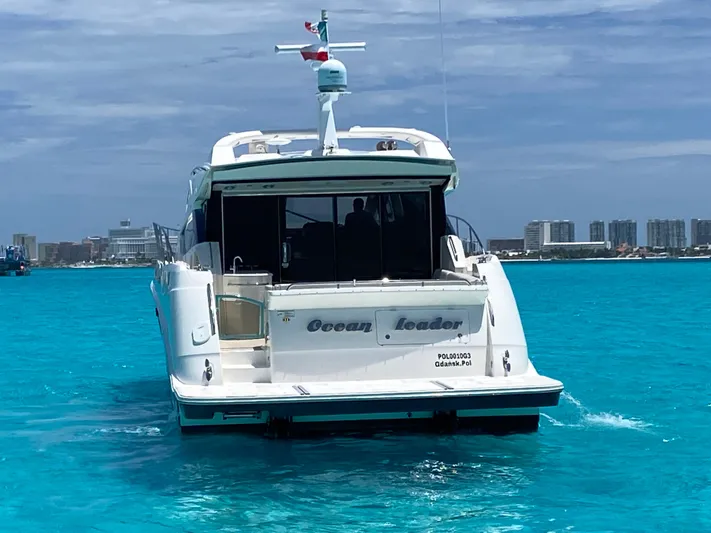 2018 Sea Ray L590 @ Cancun Yacht Photos Pics 2018 Sea Ray L590 yacht cruising in clear blue waters near a city skyline.