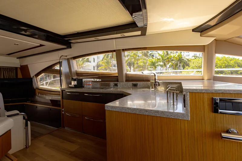 2018 Sea Ray L590 @ Cancun Yacht Photos Pics Luxurious interior of 2018 Sea Ray L590 yacht with modern kitchen and panoramic windows.