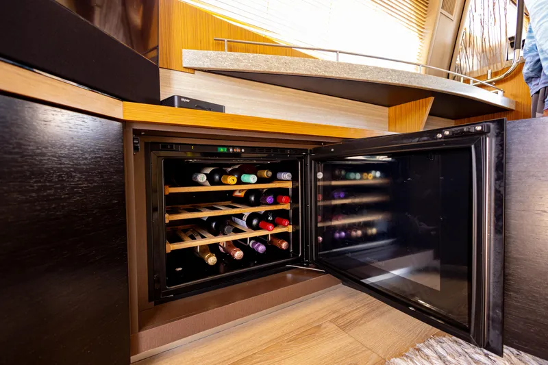 2018 Sea Ray L590 @ Cancun Yacht Photos Pics Wine cooler in 2018 Sea Ray L590 yacht interior, showcasing luxury amenities.