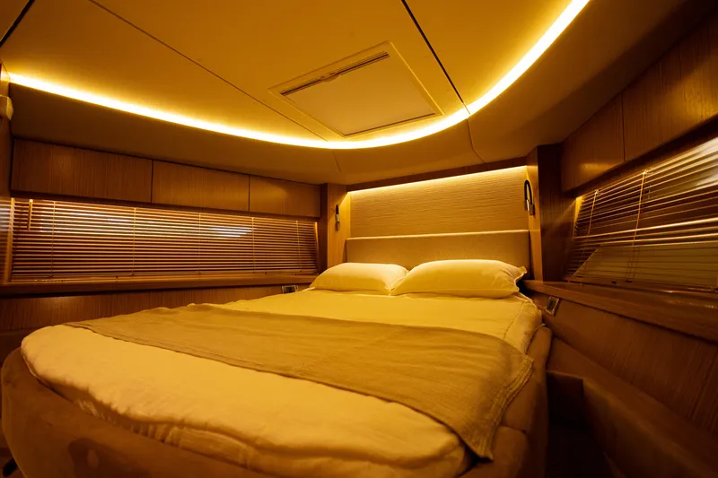 2018 Sea Ray L590 @ Cancun Yacht Photos Pics Luxurious bedroom interior of 2018 Sea Ray L590 yacht with ambient lighting.