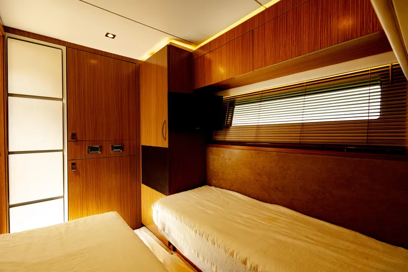 2018 Sea Ray L590 @ Cancun Yacht Photos Pics Luxurious cabin interior of 2018 Sea Ray L590 yacht with twin beds and wooden finish.