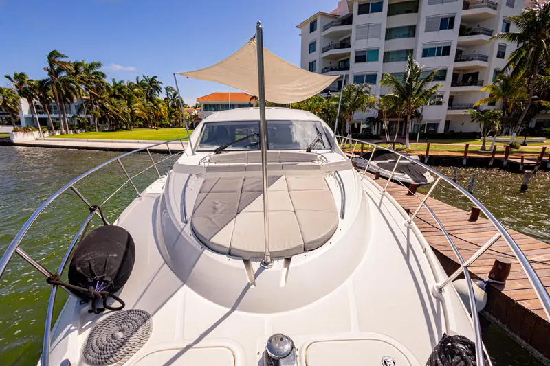 2018 Sea Ray L590 @ Cancun Yacht Photos Pics 2018 Sea Ray L590 yacht docked near waterfront apartments, featuring a sunshade and spacious deck.