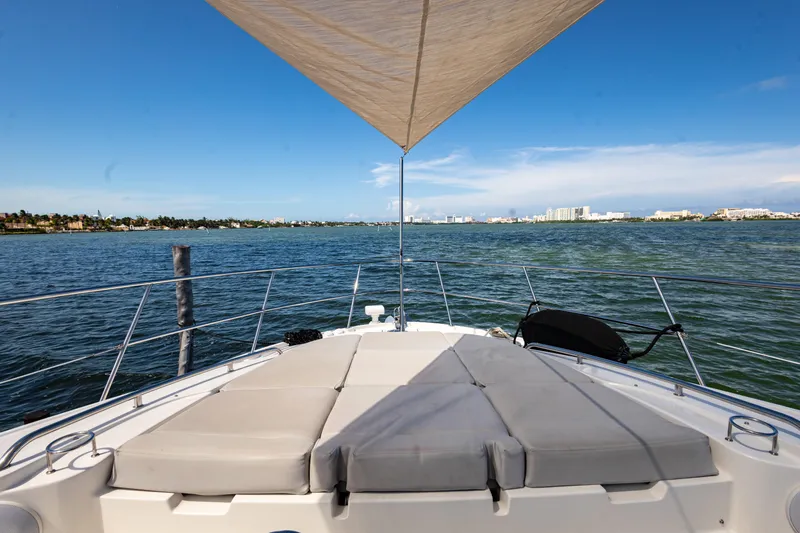2018 Sea Ray L590 @ Cancun Yacht Photos Pics 2018 Sea Ray L590 yacht with sunshade, cruising on calm waters under a clear blue sky.