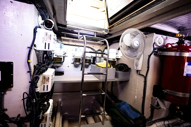 2018 Sea Ray L590 @ Cancun Yacht Photos Pics Engine room of 2018 Sea Ray L590 yacht with ladder, fan, and equipment.