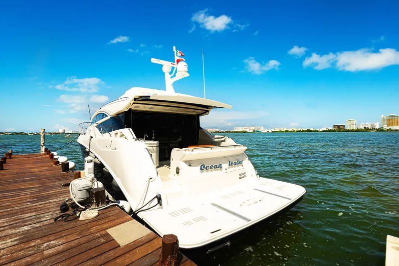 2018 Sea Ray L590 @ Cancun Yacht Photos Pics 2018 Sea Ray L590 yacht docked by a wooden pier under a clear blue sky.