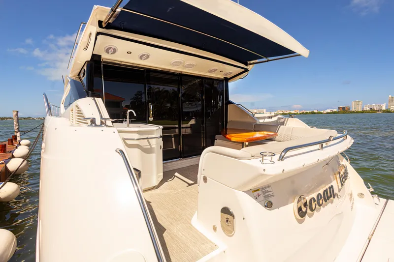 2018 Sea Ray L590 @ Cancun Yacht Photos Pics 2018 Sea Ray L590 yacht with outdoor seating and scenic waterfront view.