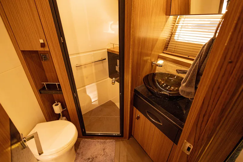 2018 Sea Ray L590 @ Cancun Yacht Photos Pics Luxurious bathroom in 2018 Sea Ray L590 yacht with modern fixtures and wooden accents.