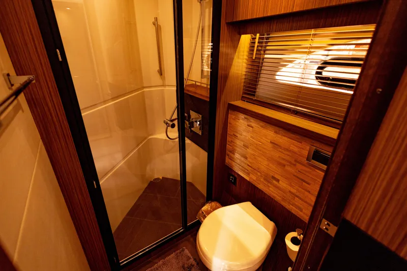 2018 Sea Ray L590 @ Cancun Yacht Photos Pics Luxurious bathroom in 2018 Sea Ray L590 yacht with shower and wooden accents.